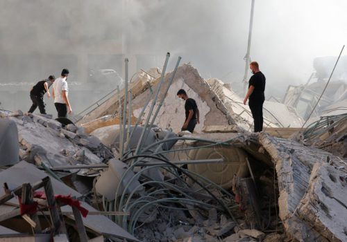 People look at the damage in the aftermath of Israeli strikes in Chiyah, amid the ongoing hostilities between Hezbollah and Israeli forces, Lebanon October 2, 2024. REUTERS/Mohamed Azakir