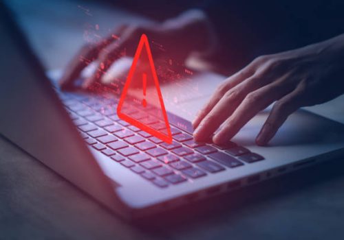 System hacked warning alert on notebook (Laptop). Cyber attack on computer network, Virus, Spyware, Malware or Malicious software. Cyber security and cybercrime. Compromised information internet.