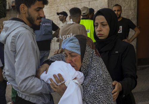 Outside al-Aqsa hospital in Deir el-Balah, central Gaza Strip, a Palestinian woman kisses the sheet-covered body of a child killed during an Israeli airstrike, Sunday, Oct. 15, 2023. (AP Photo/Adel Hana)
